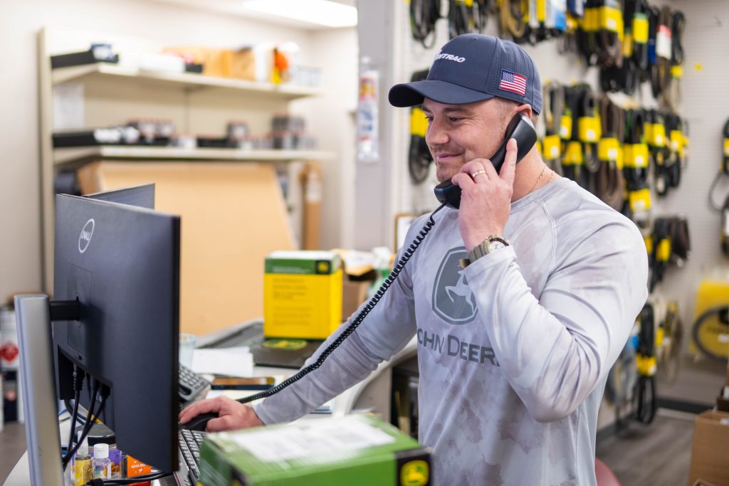 employee talking on the phone at a computer