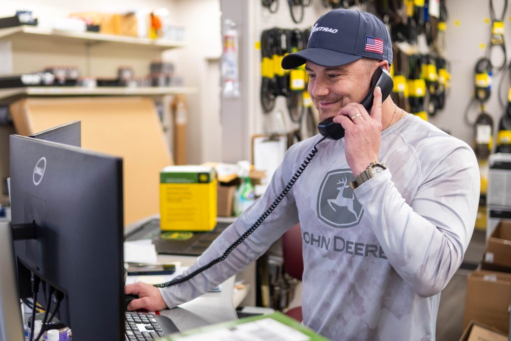 employee talking on the phone at a computer